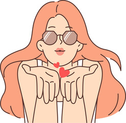 Romantic woman blows kiss and looks at screen to seduce and charm or invite viewer on date