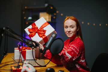 A girl blogger is doing a Christmas giveaway on her channel. Portrait of a girl in a Christmas...
