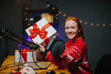 A girl blogger is doing a Christmas giveaway on her channel. Portrait of a girl in a Christmas...