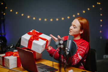 A girl blogger is doing a Christmas giveaway on her channel. Portrait of a girl in a Christmas...