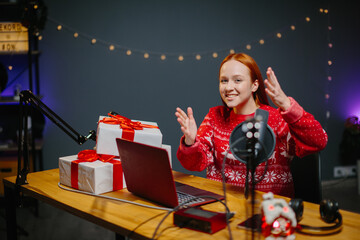 A girl blogger is doing a Christmas giveaway on her channel. Portrait of a girl in a Christmas...
