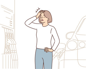 Shocked woman filling car at gas station opens mouth at high price of fuel driven up by inflation