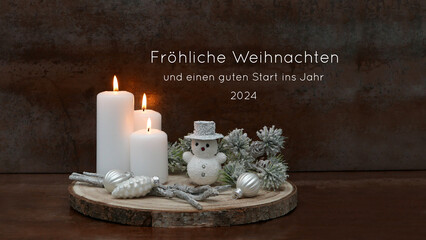 Weihnachtskarte:  Weiße Kerzen, Weihnachttsschmuck und ein Schneemann auf einer Holzscheibe...