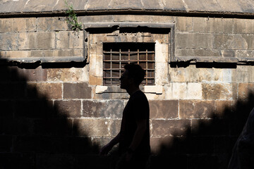 silhouette of a person standing near the wall