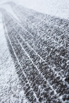 Wheel tracks on the road covered with snow