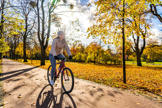 Woman riding bicycle in city park