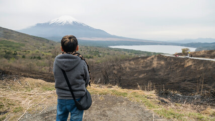Asian boy on top of Yamanakako Panoramadai look mt. Fuji view