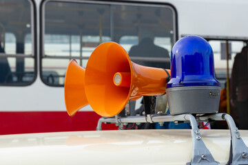 Details of retro police car with a megaphone and flashing blue siren light mounted on top....