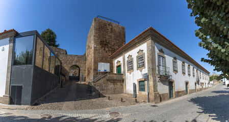 View at the Santiago tower and gate, one of the main entrances to the historic and ancient city of Pinhel, within the medieval walls - obrazy, fototapety, plakaty