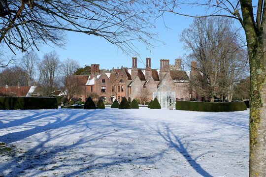 Chenies Manor House, a Tudor Grade I listed building, in winter snow
