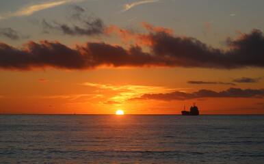 Photos of an amazing sunset at sea with ships - 676910502