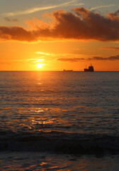 Photos of an amazing sunset at sea with ships - 676910513