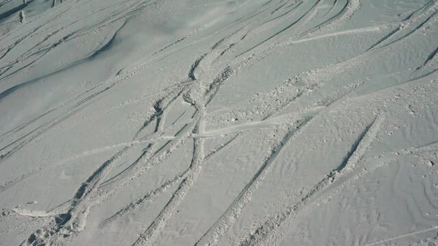 deep trace from ski and snowboard on snow winter mountain slope, freeride