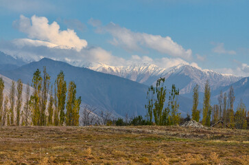 scenic view of snow covered peaks of Chatkal ridge from Charvak reservoir (Yusufhona, Tashkent region, Uzbekistan)