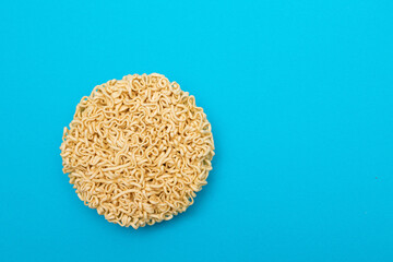 Uncooked Instant Noodles on Blue Background. Raw Pasta. Dry Asian Fast Food. Quick Lunch