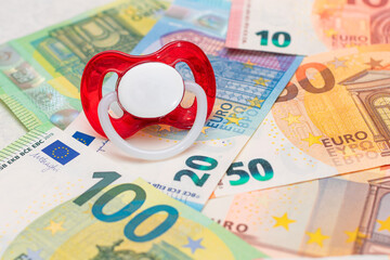 Childfree, Contraception and Birth Control Concept: Baby Pacifier on the Euro Banknotes. Having Children is Expensive and Unprofitable - obrazy, fototapety, plakaty