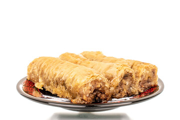 Three pieces of sweet baklava on a ceramic plate, close-up, isolated on white background.