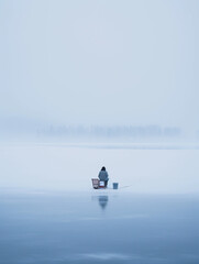 Fototapeta na wymiar Subdued hues, soft blues, and whites, the silent solitude of ice fishing. Minimalist, cold temperature color scheme