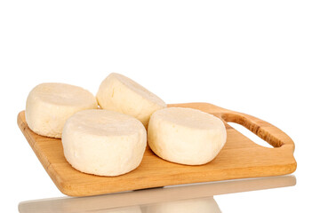 Several frozen semi-finished cheesecakes on a wooden kitchen board, macro, isolated on white background.