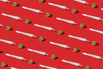 Cannabis bud and joint for smoking. Pattern on a red background - 676921552