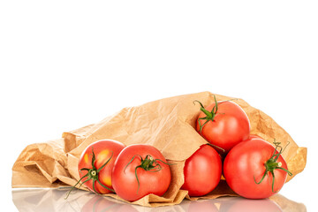 Several pink juicy tomatoes with paper bag, macro, isolated on white background.