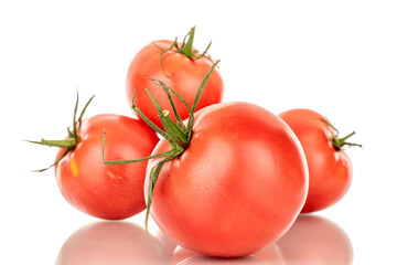 Several pink juicy tomatoes, macro, isolated on white background.