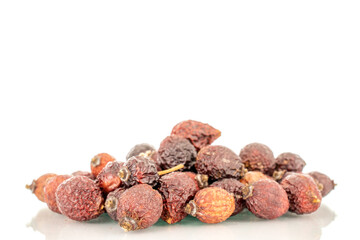 Several dry rosehip berries, macro, isolated on white background.