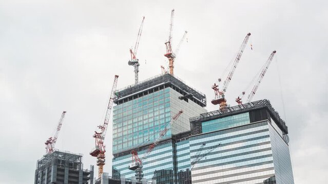 Time lapse of crane operating on under construction building, skyscraper cityscape view. Civil engineering industry technology, developing industrial country concept