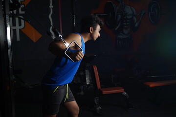 Fototapeta na wymiar Indian male doing lifting exercises at the gym