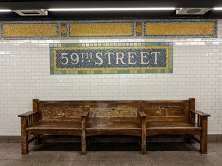 59th street subway sign above a wooden bench in Manhattan, New York City, USA