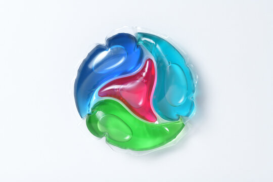 Extreme macro photography of laundry pod - 4 in 1 disc isolated on white background