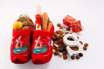 Dutch children shoes filled with treats, traditional sweets pepernoten and chocolate letter for St...