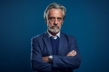 Fototapeta premium Older, Elegant Man in a Business Suit Poses Gracefully Against a Serene Blue Background, Symbolizing Timeless Sophistication and Authority, AI generated