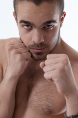 Young fighter stands prepared, intensely focused