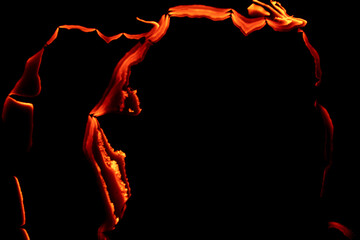 burning paper, glowing edge of paper on a black background