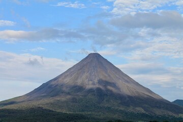 Huge volcanic mountain with blue sky in the background