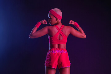 Sporty fit woman, athlete make fitness exercises on neon background. Download cover for music collection for fitness classes. Sports recreation. Beautiful black young woman.