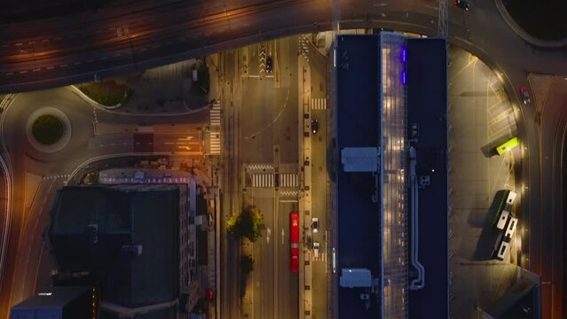 Birds eye shot of streets and buildings in evening city. Illuminated road and modern town development. Oslo, Norway