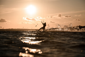 Female wakeboarder rides a wakeboard, holding on to a comfortable handle on a cable