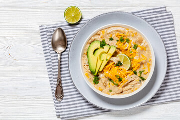 white chicken chili with cheese, avocado in bowl
