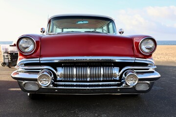 front view of a 1950s red muscle car 