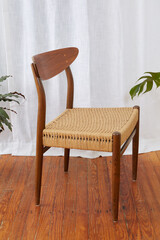 Vintage minimalist cord chair.  Elegant Mid-Century Modern design. Side view photograph with long...