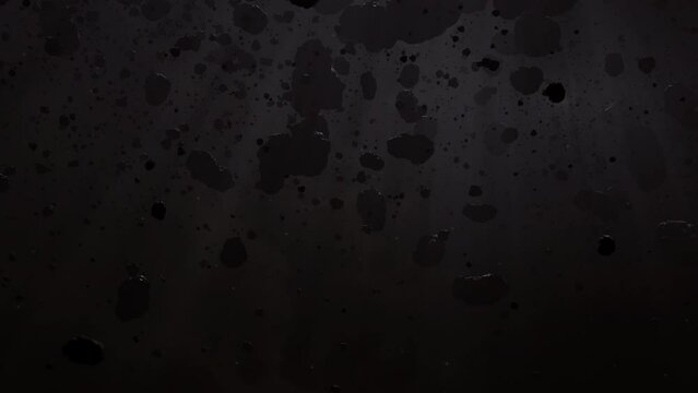 Asteroid belt field in dark outer space. 3D animation wide tracking shot. Rock formations of cosmic debris and giant Meteorites. Celestial objects on black background with dust nebula haze low light