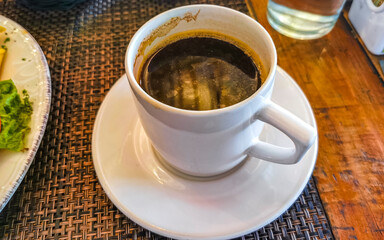 Cup of americano black coffee in restaurant cafe in Mexico.