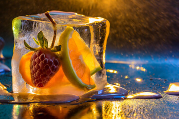 Fruits in ice cubes on a glass