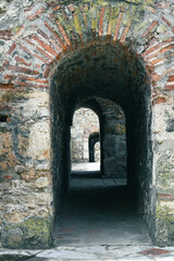 Ancient Fortress. arch door made by stone place. old brick wall background. 