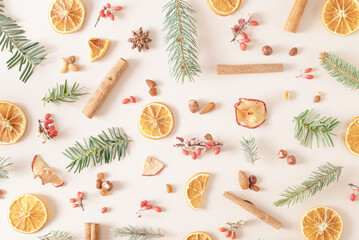 Christmas background made of natural branches, dry oranges fruits, anise, nuts, apple and cinnamon ...