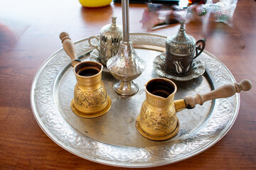 Traditional Tunisian Coffee, Closeup of ornamental decorative silver and gold cup and saucer with tea or coffee