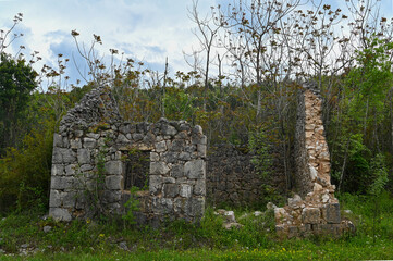 Abandoned destroyed old stone house in the village