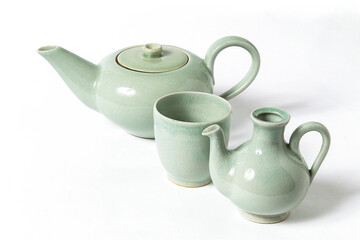 Japanese ceramics, traditional Japanese green teapot and cups on white background with space for your text or design  